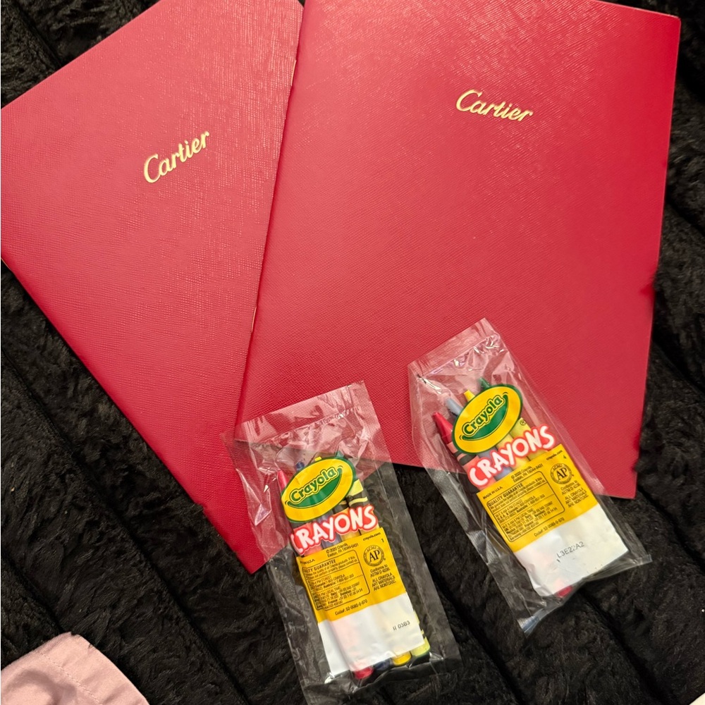 2 Cartier coloring books with crayons.